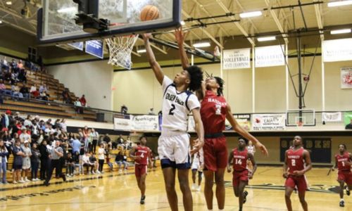 Jacksonville’s Cam Johnson hits the layup that put him at 1,000 career points in the third quarter of the Golden Eagles’ 84-45 victory over Handley in a Class 4A Northeast subregional at Jacksonville. (Photo by Greg Warren)