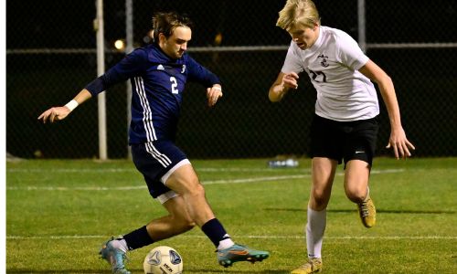 Donoho’s Bruce Downey (right) and Jacksonville’s Alex Mullins battle to control the ball during their match at Jacksonville State University’s soccer complex Tuesday. (Photo by B.J. Franklin/gunghophotos.smugmug.com)