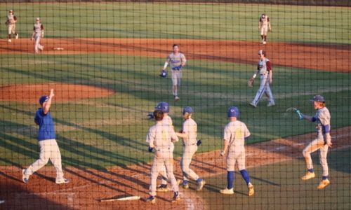 Piedmont players and coaches celebrate after beating Golden (Colo.) on Thursday. (Photo by Amy Pike)