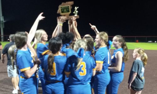 Piedmont players hoist the trophy Thursday after winning the program’s first Calhoun County fast-pitch softball title. (Photo by Joe Medley)