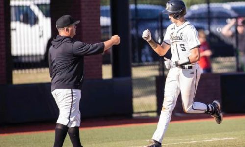 Wes Brooks congratulates Drew McCormick after McCormick hit a home run this past season. (File photo)