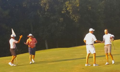 Ty Cole and Jesus Montenegro (left) and Gary Wigington and Layton Bussey shake hands after Sunday’s completion of the Buddy Moore Charity Golf Tournament at Anniston Municipal Golf Course. (Photo by Joe Medley)