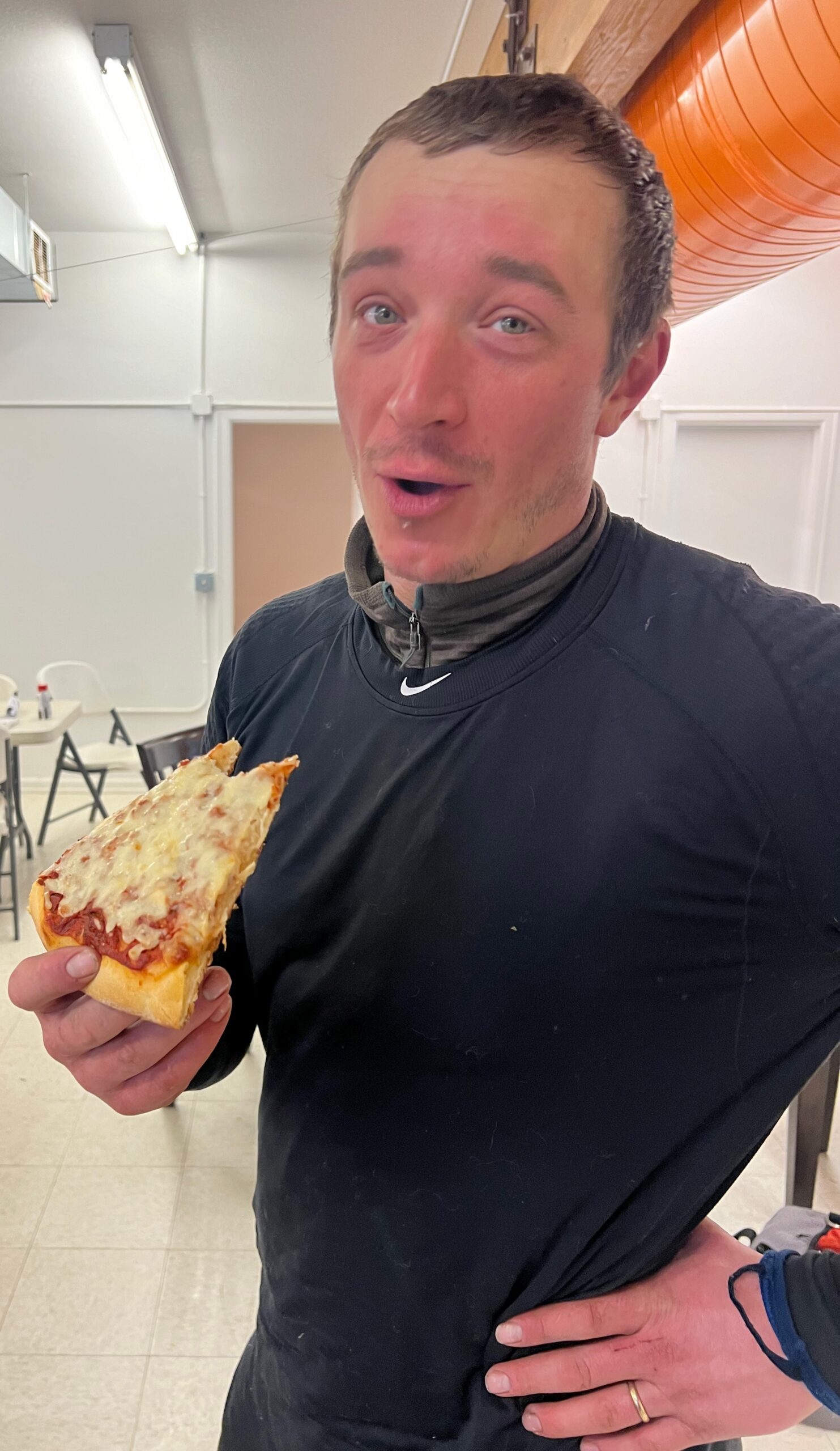 a musher eats pizza
